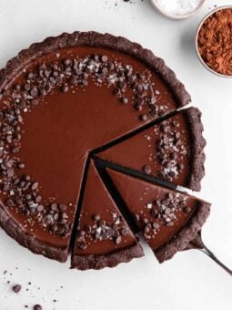 a partially sliced no-bake vegan chocolate tart