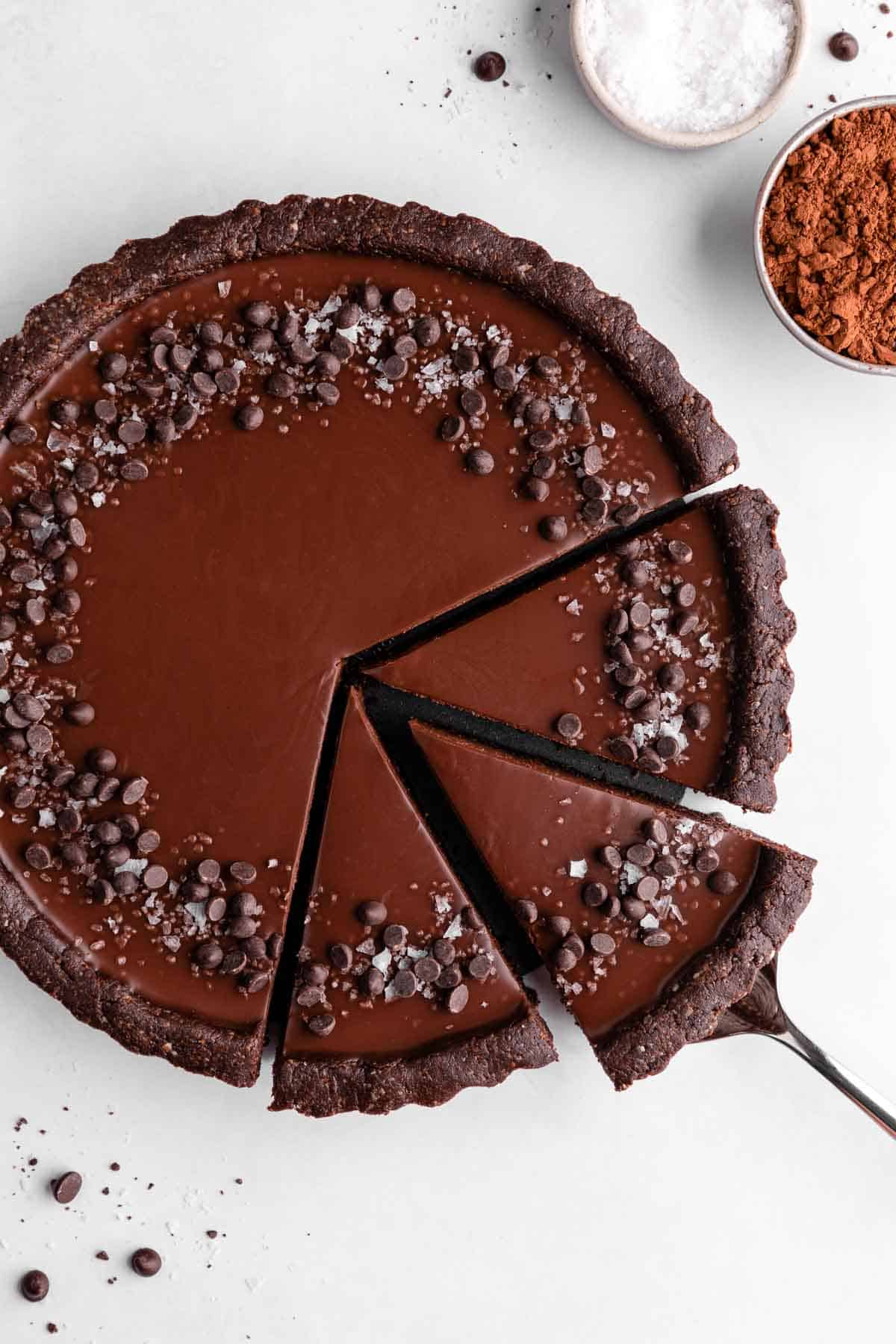 a no-bake chocolate tart with three slices cut into it