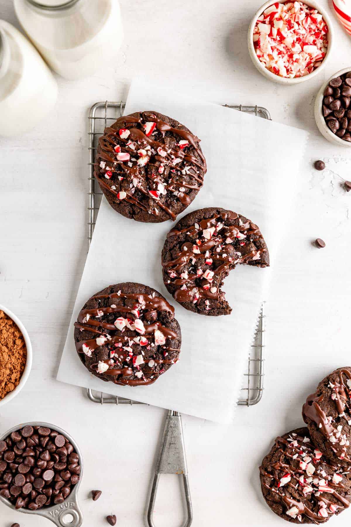 three vegan chocolate peppermint cookies on a cooling cookie rack