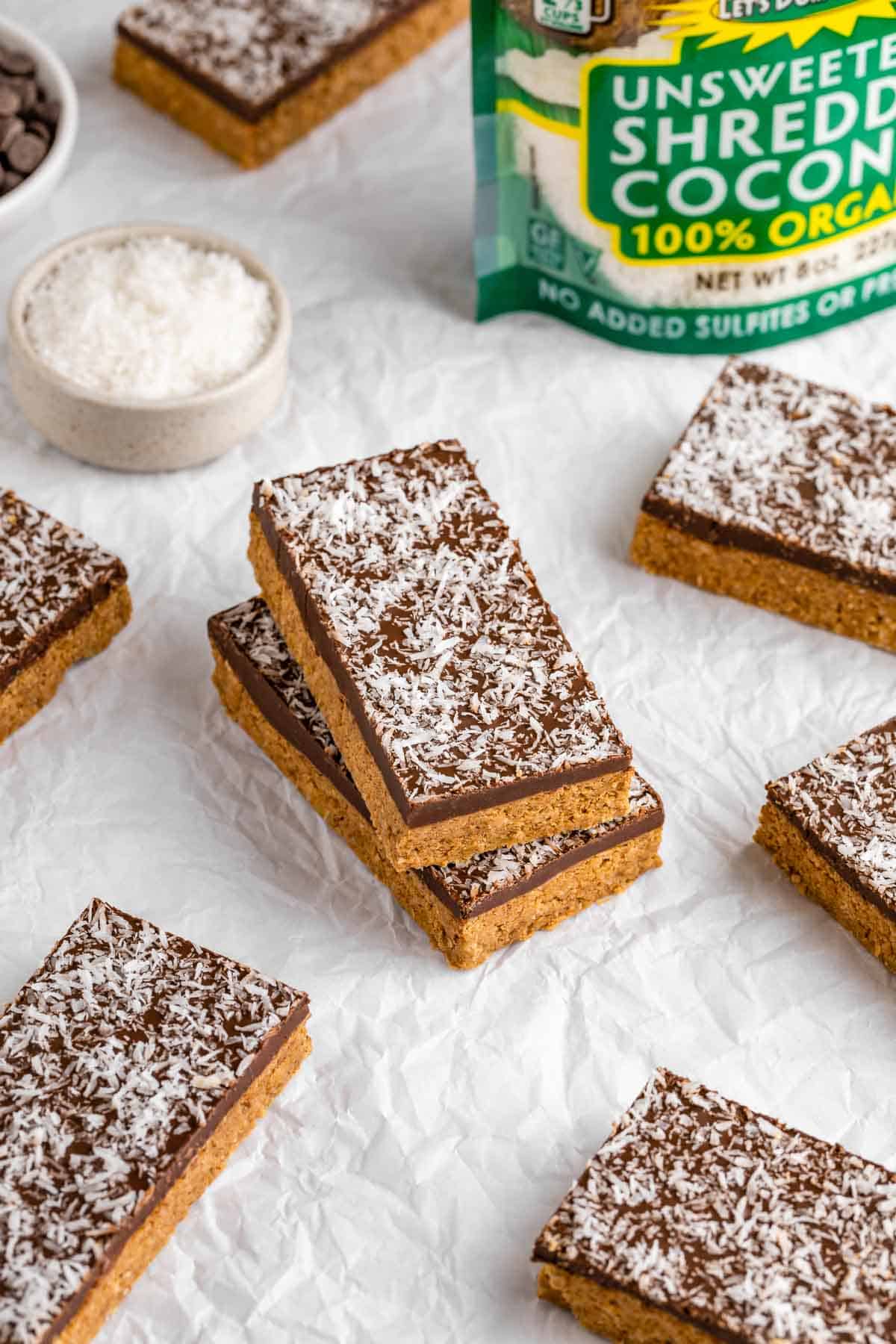 no-bake coconut protein bars on white parchment paper