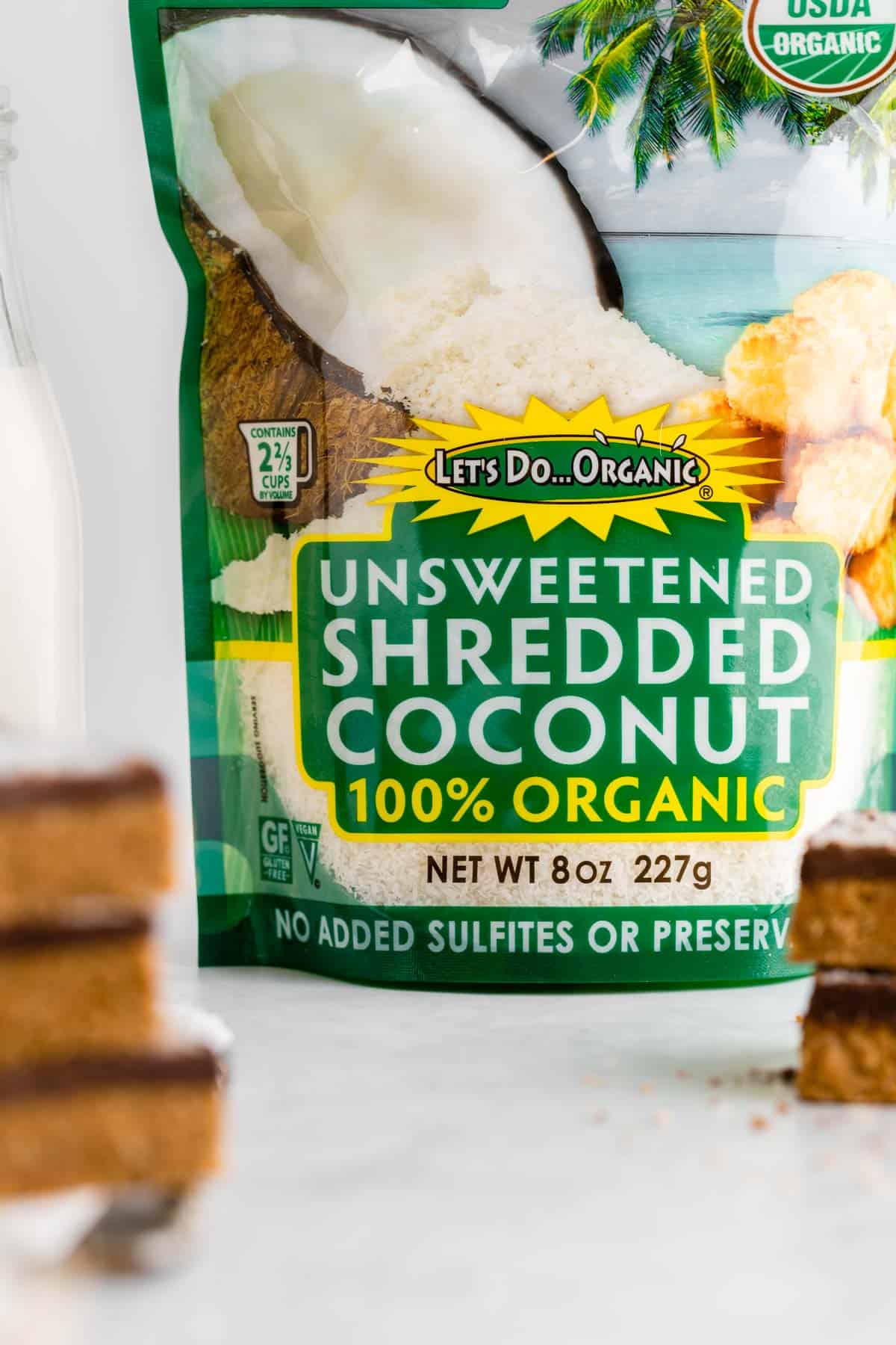 a bag of let's do organic unsweetened shredded coconut beside vegan homemade protein bars