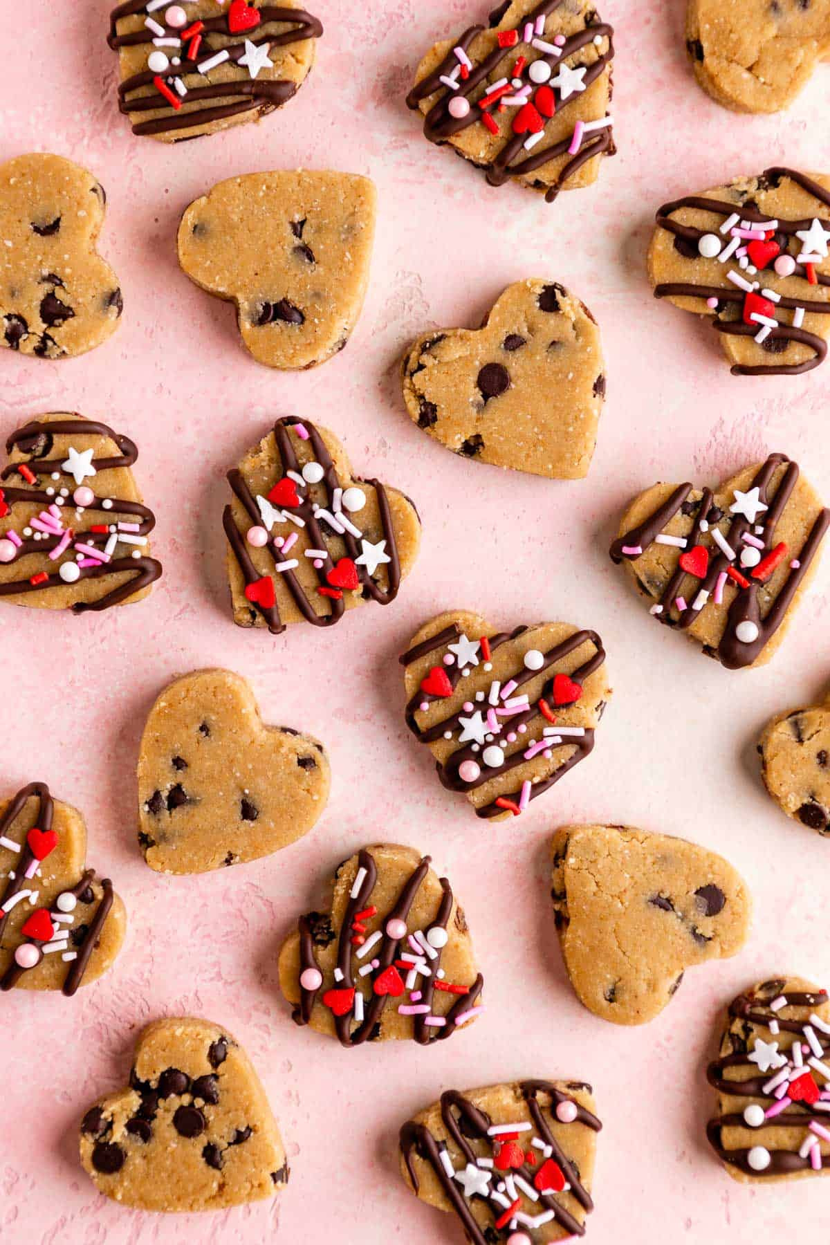 healthy cookie dough hearts with valentine's day sprinkles on a pink surface