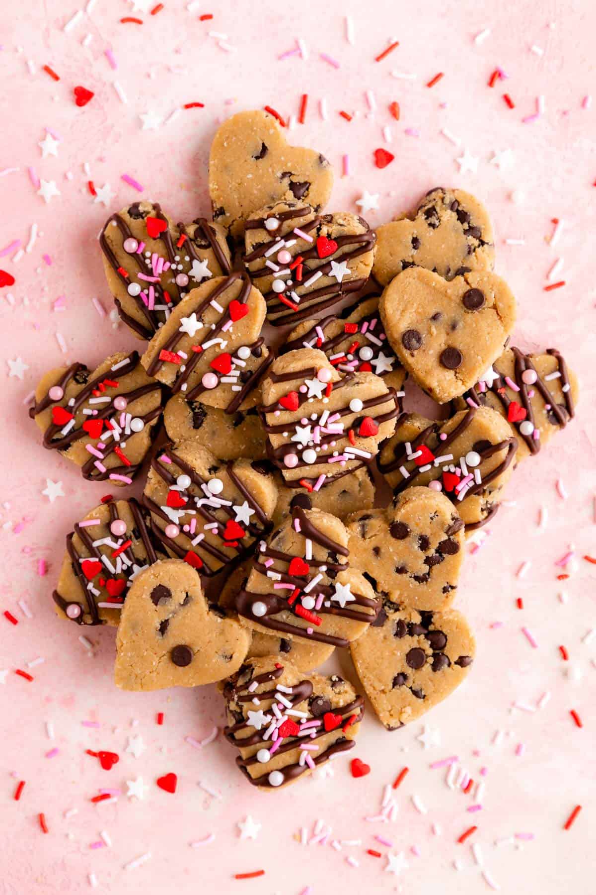 a pile of healthy chocolate chip cookie dough hearts with valentine's day sprinkles