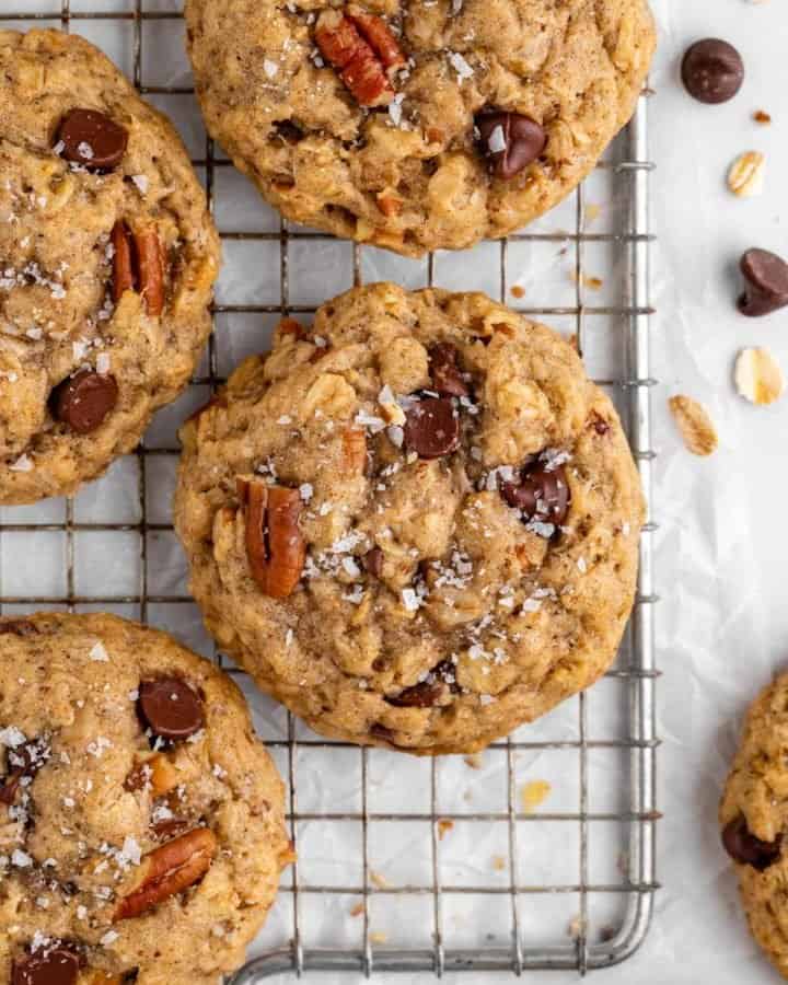 a close up of vegan cowboy cookies with oatmeal, coconut, pecans, and chocolate chips