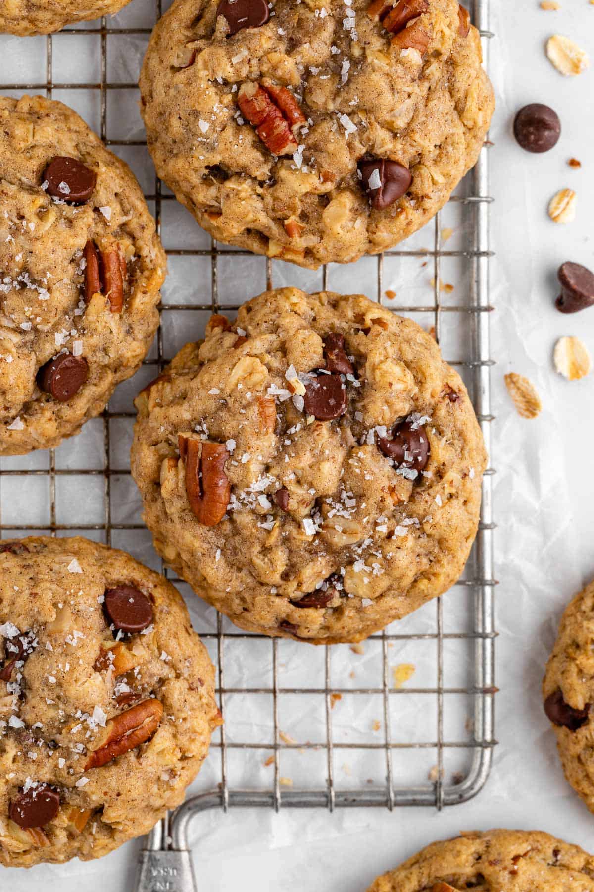 a close up of vegan cowboy cookies with oatmeal, coconut, pecans, and chocolate chips