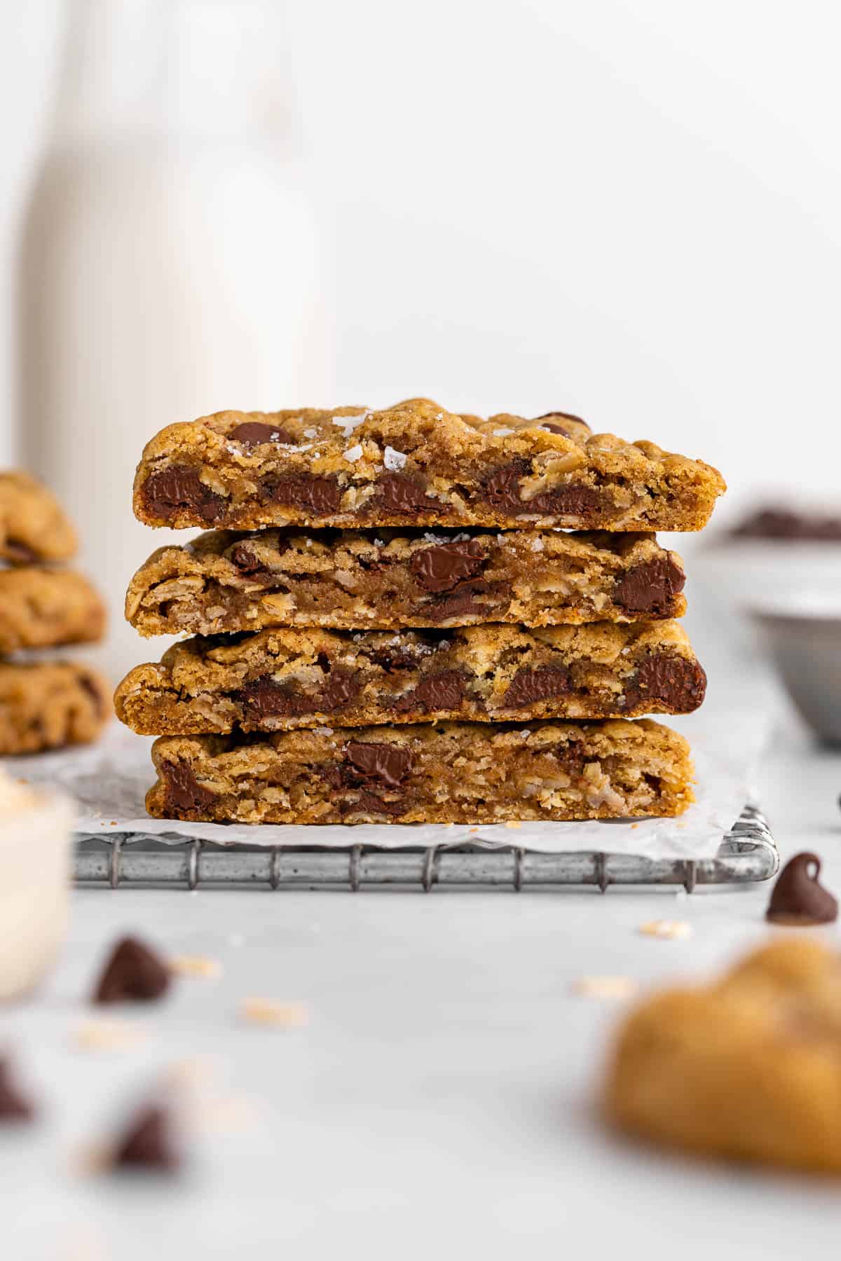 a stack of vegan oatmeal chocolate chip cookies cut in half