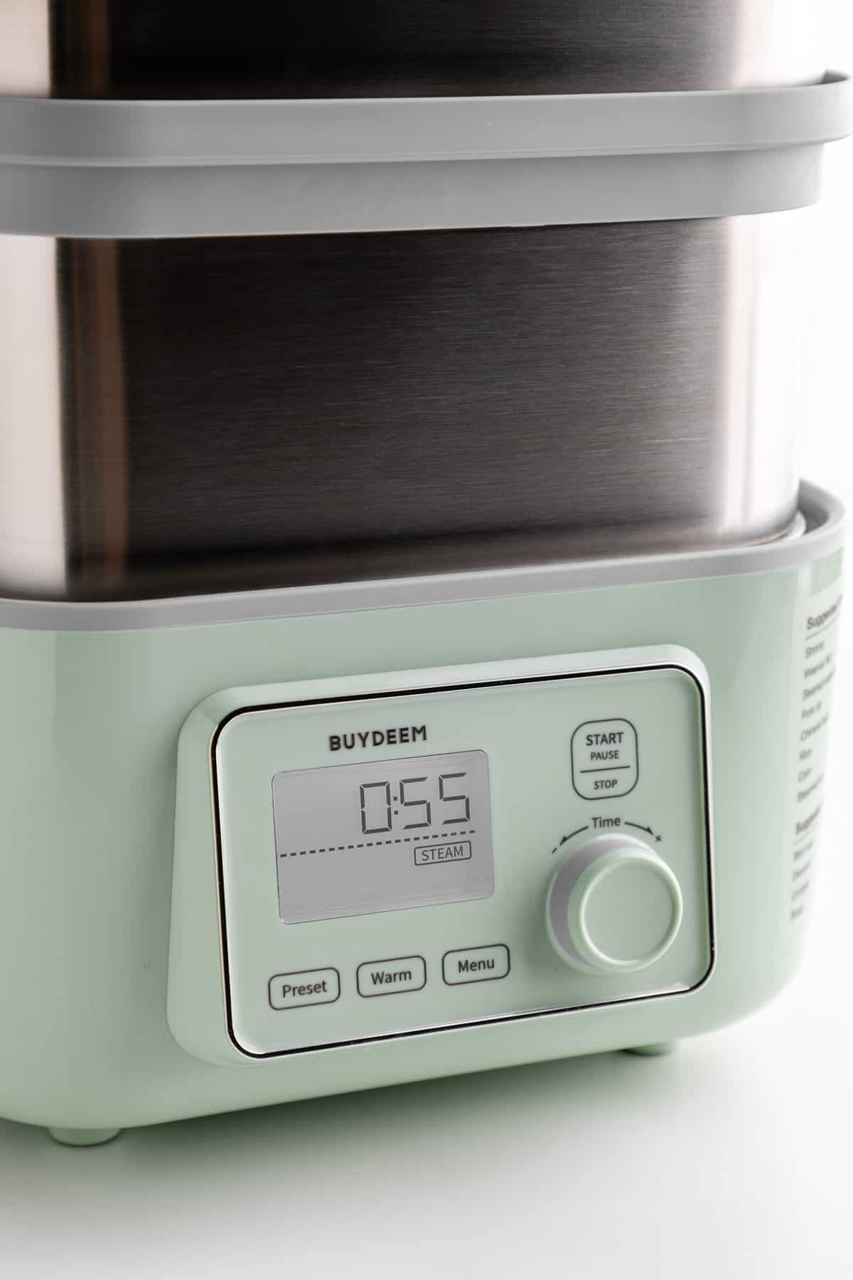 the Buydeem two-tier intelligent food steamer on slow cook mode for 55 minutes
