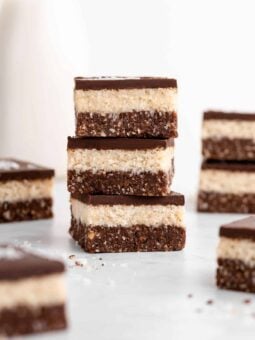 a stack of three layered no-bake coconut brownies