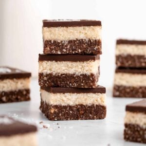 a stack of three layered no-bake coconut brownies