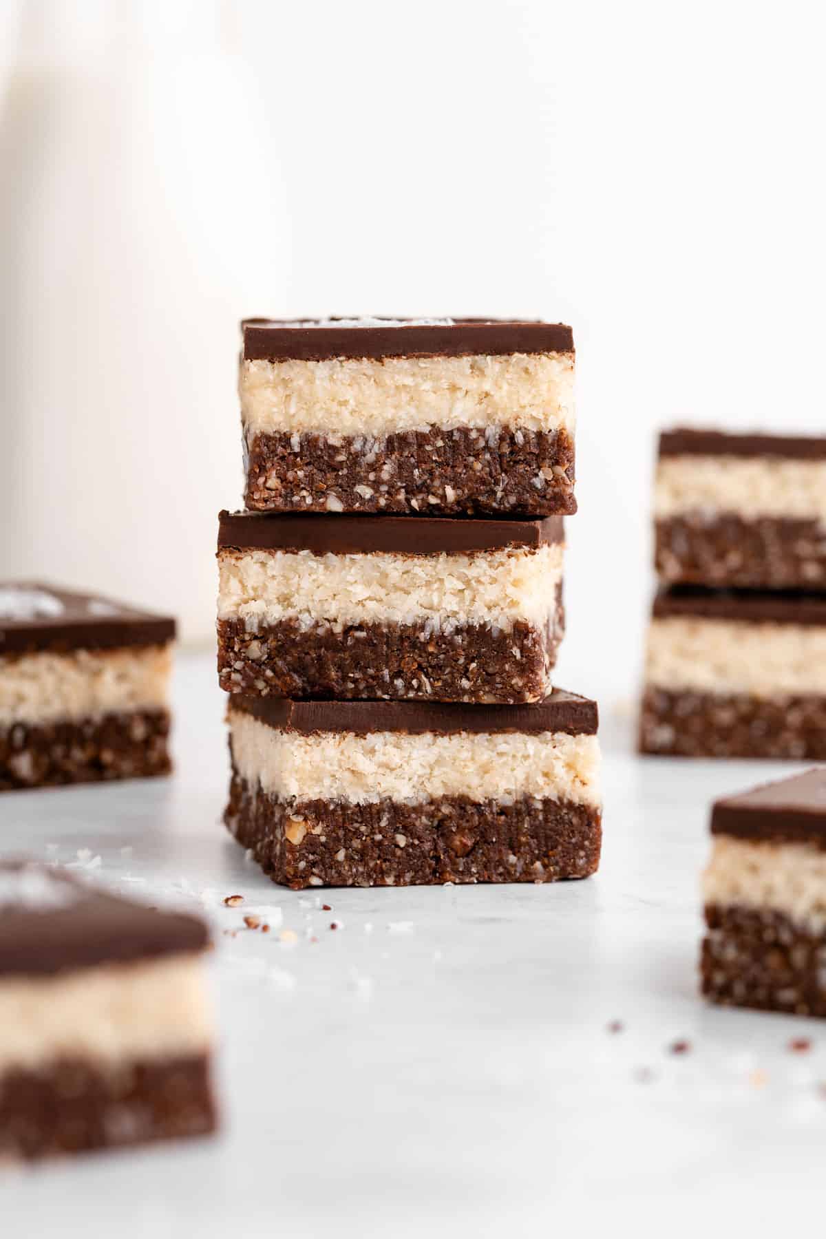 a stack of three layered no-bake coconut brownies