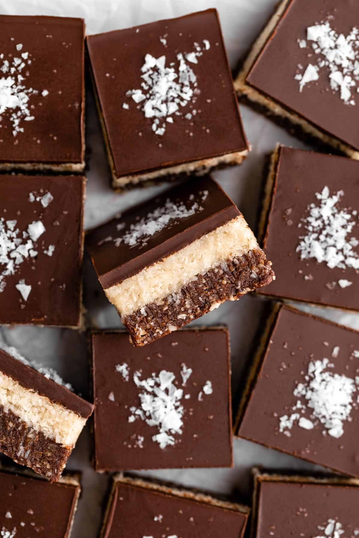 layered no-bake coconut brownies with chocolate on top