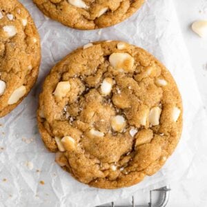 vegan white chocolate macadamia nut cookies on a wire cooling rack