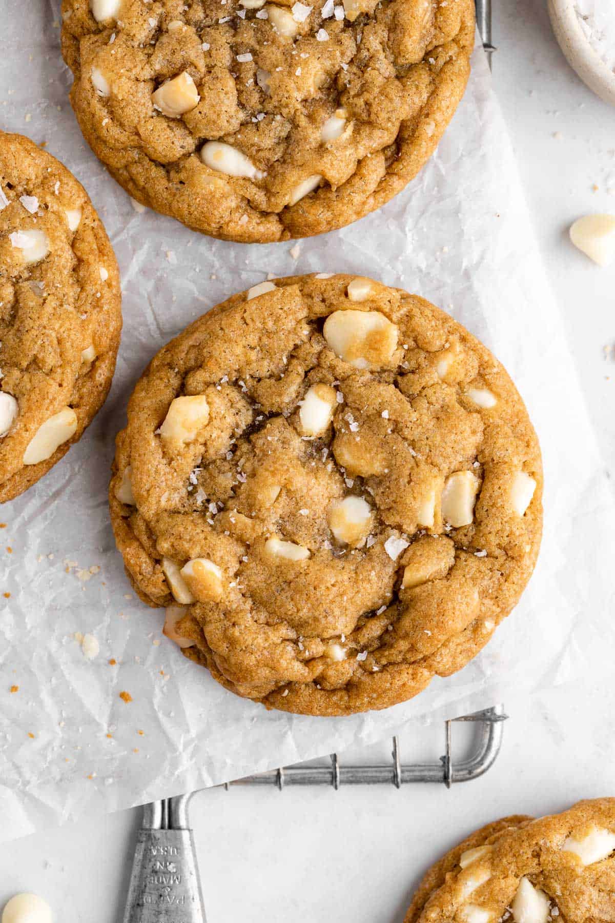 vegan white chocolate macadamia nut cookies on a wire cooling rack