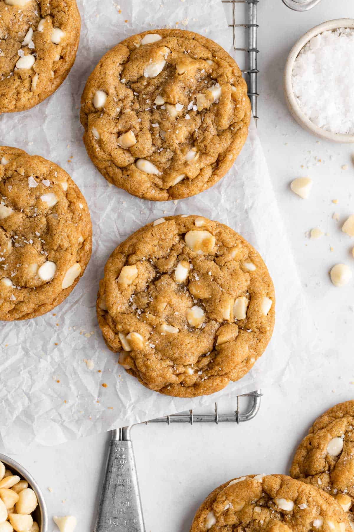 vegan white chocolate macadamia nut cookies on a wire cooling rack