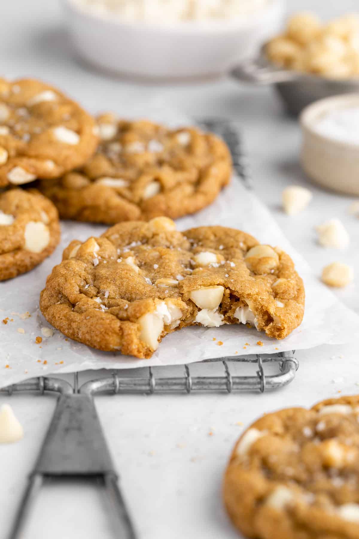 a half bitten vegan white chocolate macadamia nut cookie