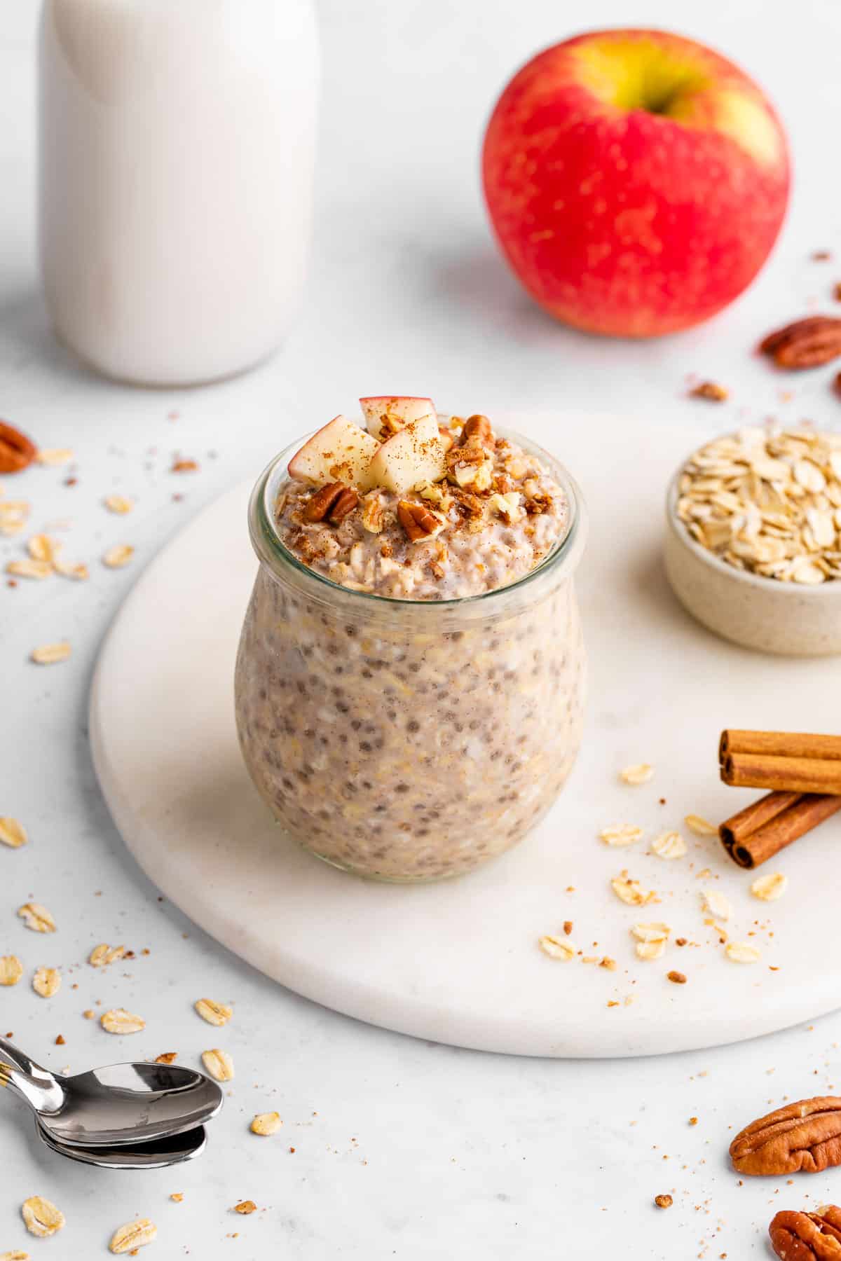 vegan apple cinnamon overnight oats in a jar with diced apples on top