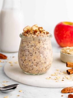 vegan apple cinnamon overnight oats in a jar with chia seeds and yogurt