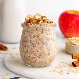 vegan apple cinnamon overnight oats in a jar with chia seeds and yogurt