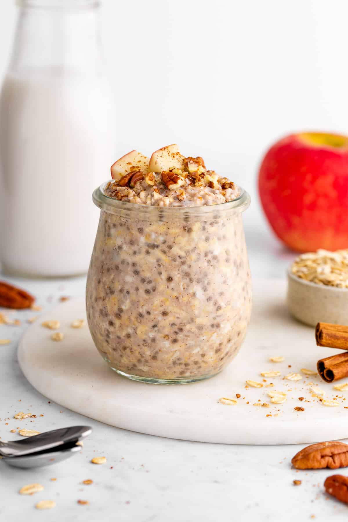 vegan apple cinnamon overnight oats in a jar with chia seeds and yogurt