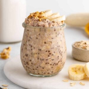 vegan banana overnight oats in a jar with chia seeds, rolled oats, and almond milk