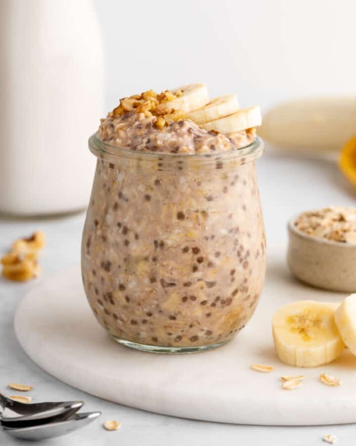 vegan banana overnight oats in a jar with chia seeds, rolled oats, and almond milk