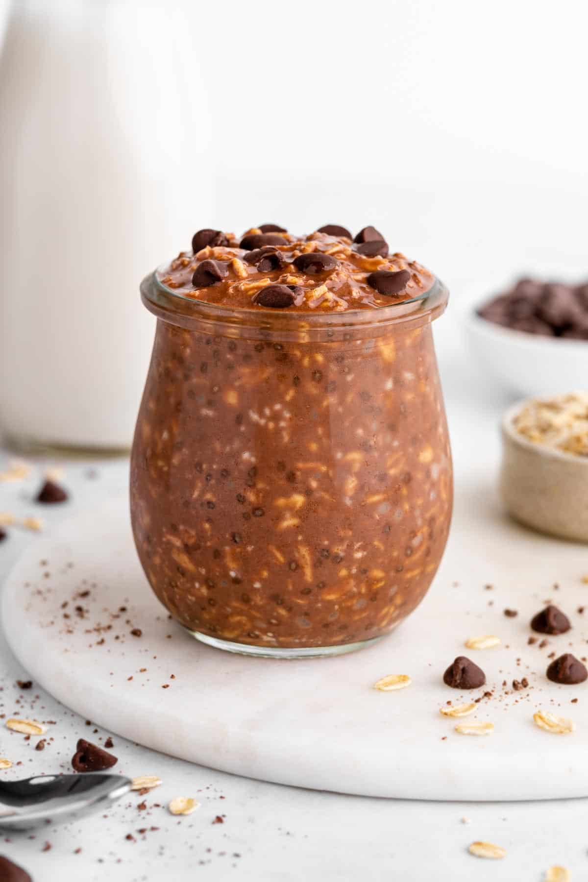 a jar of vegan chocolate overnight oats with chocolate chips
