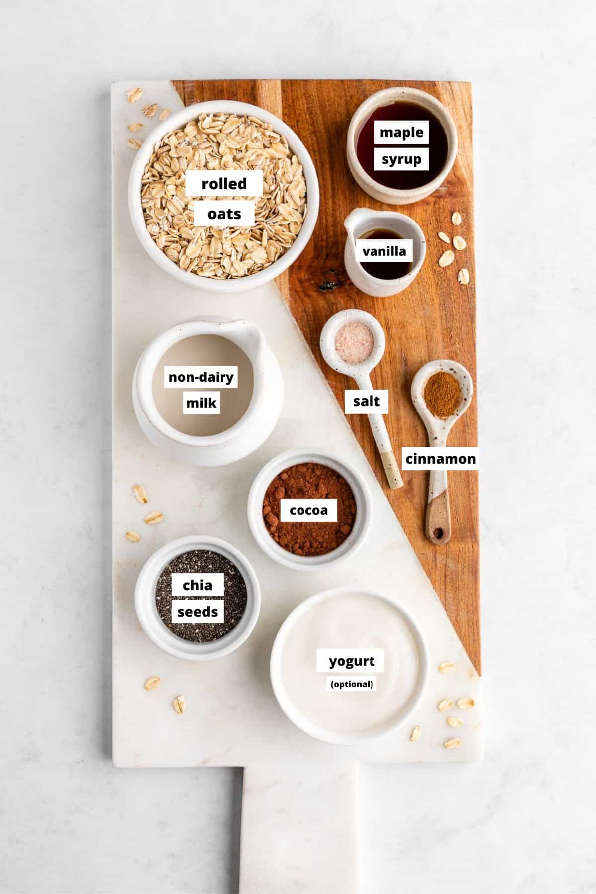 a wooden serving board topped with bowls of ingredients for vegan chocolate overnight oats