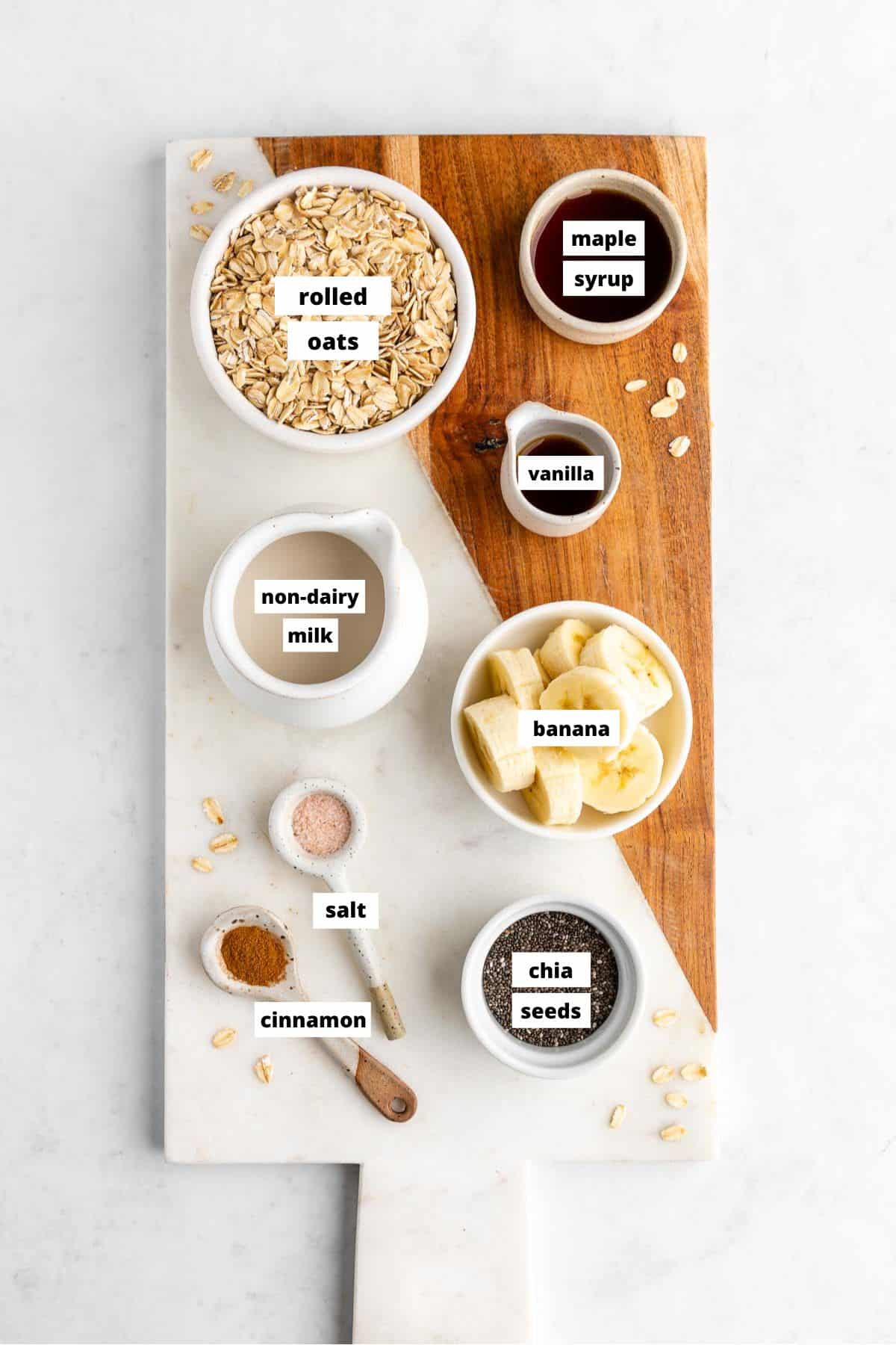 wooden cutting board topped with ingredients for banana overnight oats