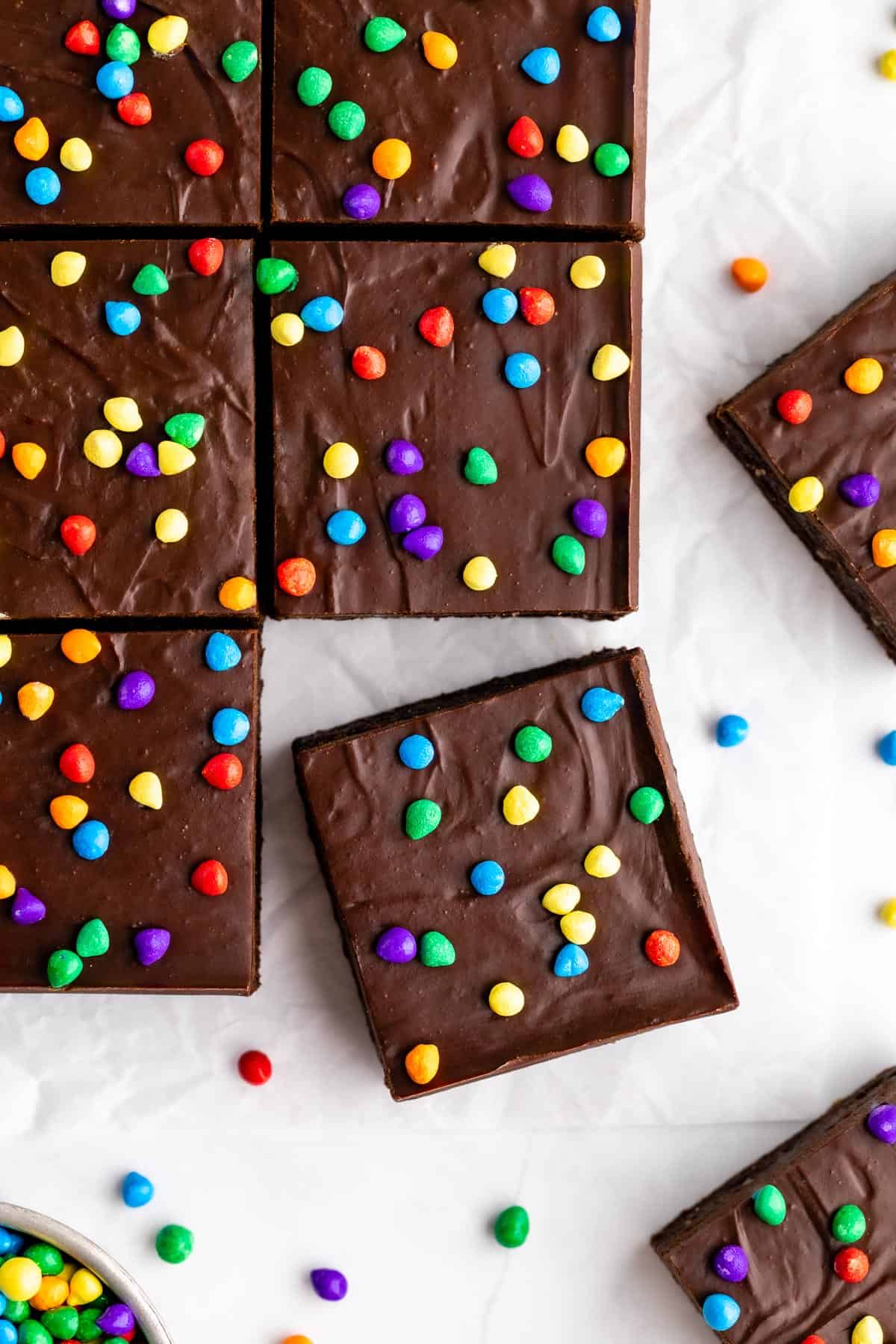 a pile of sliced no-bake homemade cosmic brownies with rainbow chips