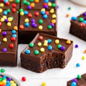 no-bake vegan cosmic brownies with a bite taken out of the middle one