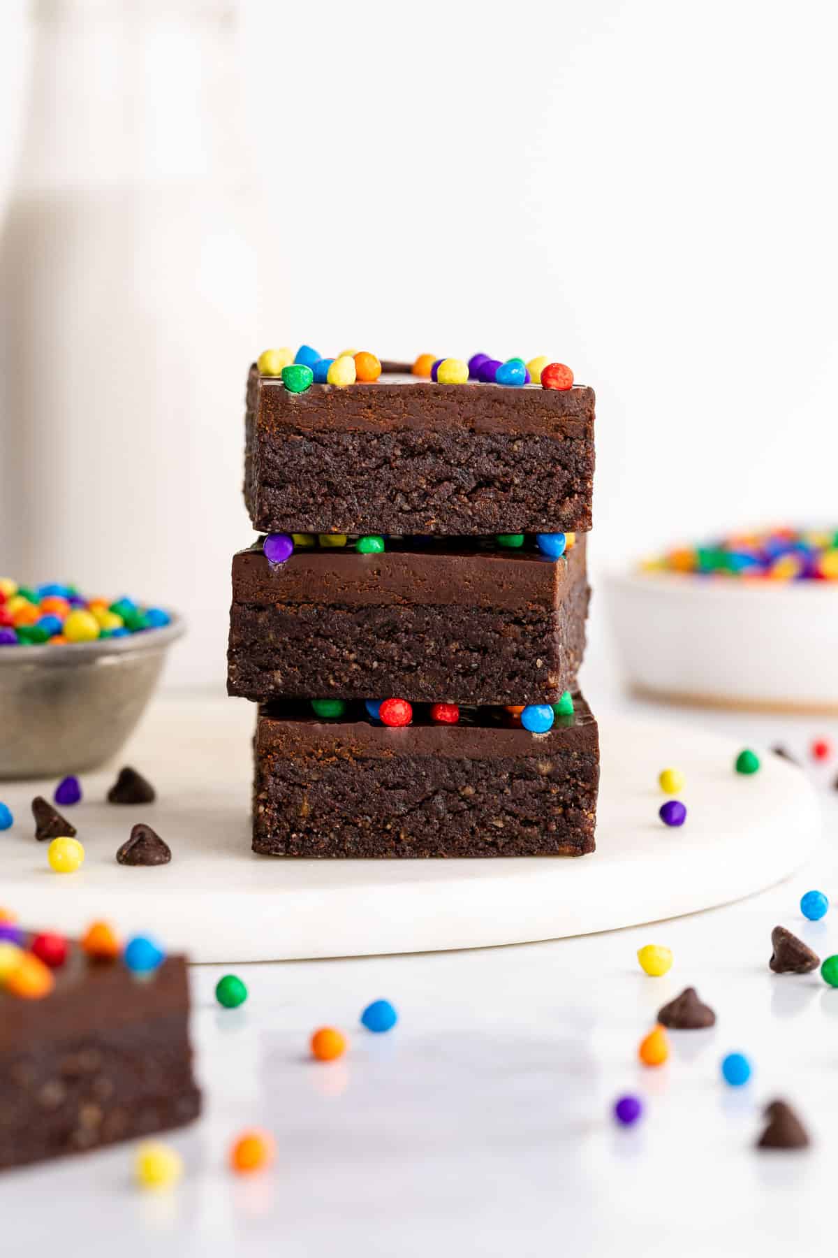 a stack of three homemade cosmic brownies with rainbow chips