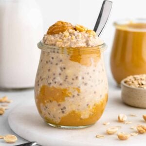a jar of vegan peanut butter overnight oats with yogurt, chia seeds, and almond milk