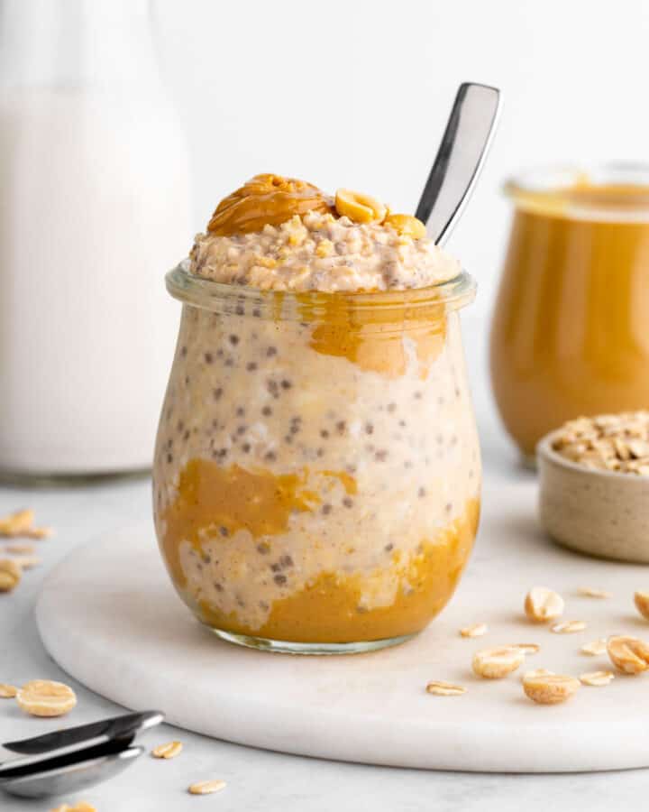 a jar of vegan peanut butter overnight oats with yogurt, chia seeds, and almond milk