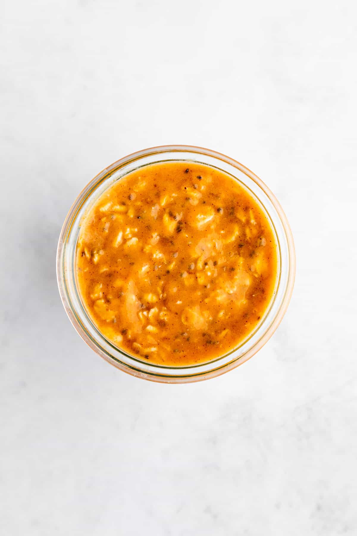 overhead photo of a mason jar filled with pumpkin overnight oats