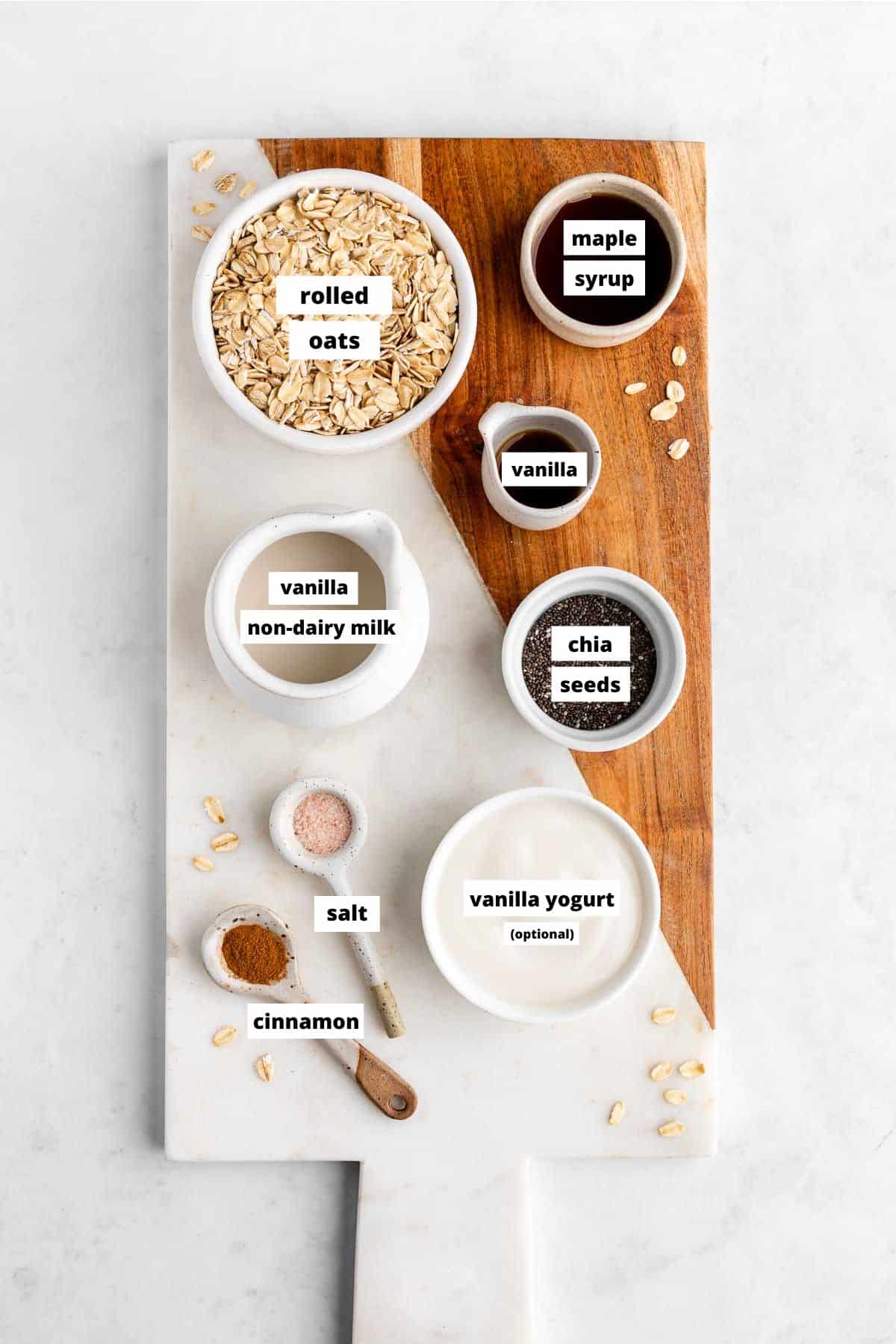 wooden serving board topped with ingredients for vanilla overnight oats