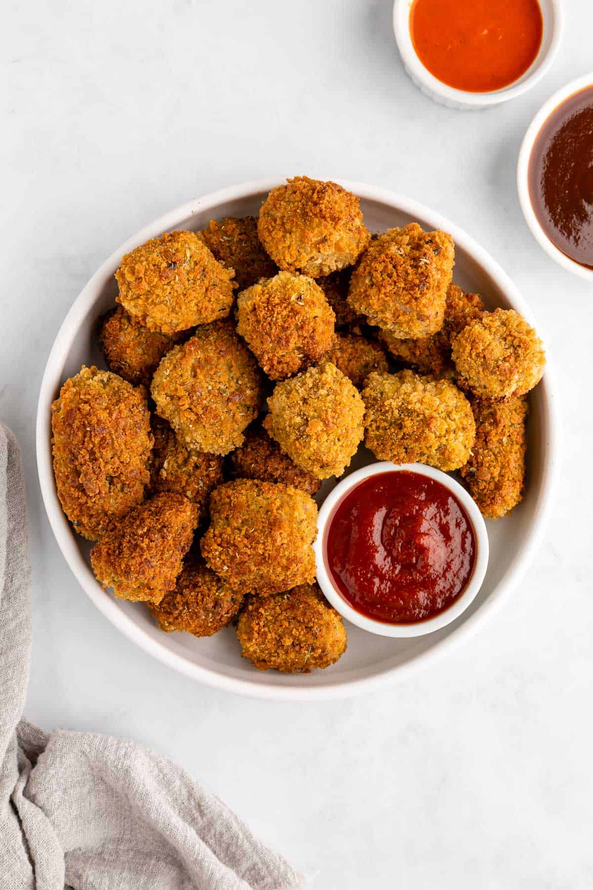 a white plate filled with crispy vegan jackfruit nuggets