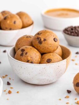 two ceramic bowls filled with vegan peanut butter protein balls