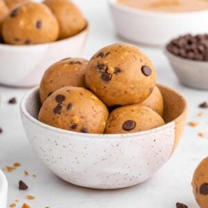 two ceramic bowls filled with vegan peanut butter protein balls