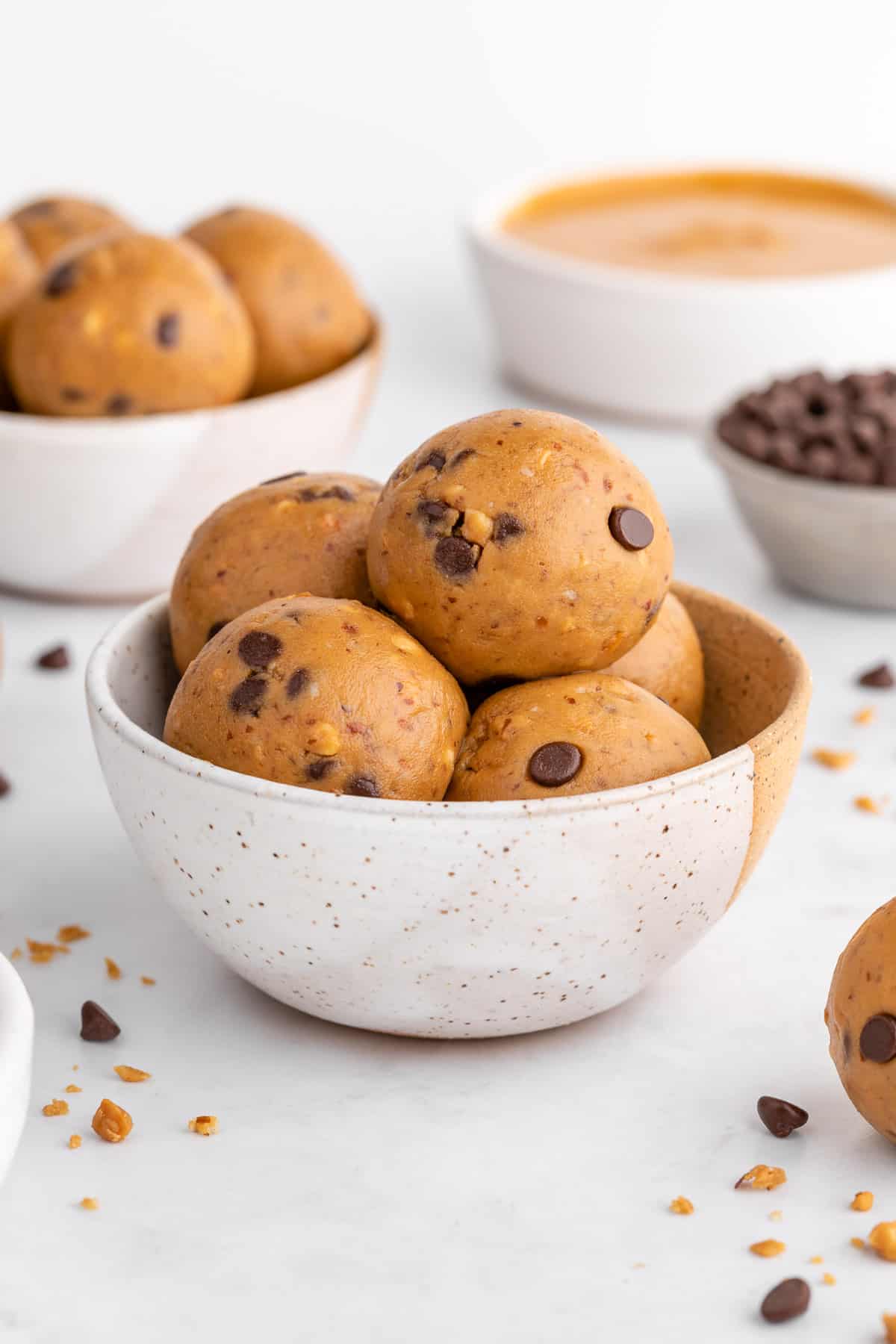 two ceramic bowls filled with vegan peanut butter protein balls