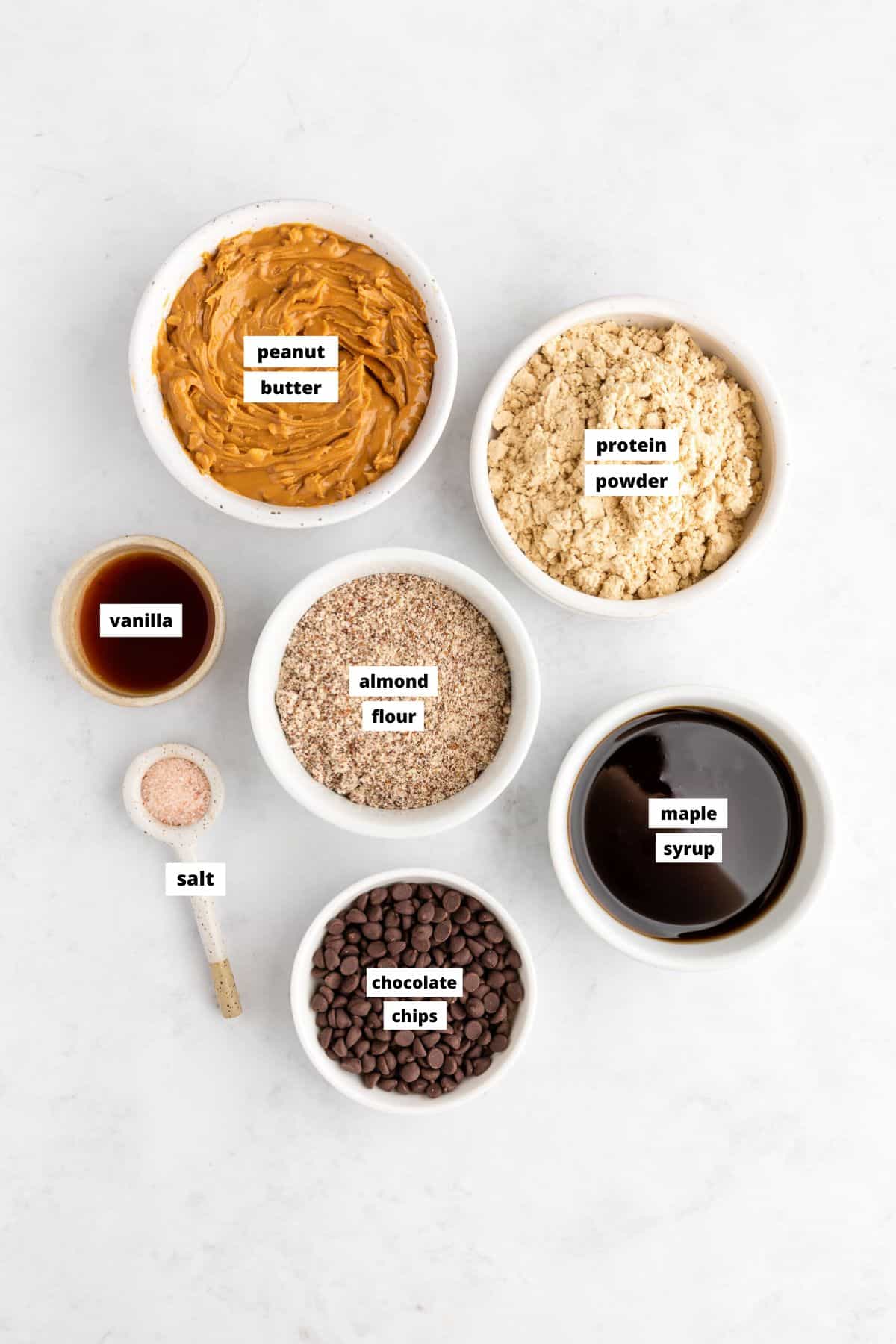 peanut butter protein balls ingredients in white bowls