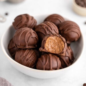 chocolate protein truffles in a white bowl