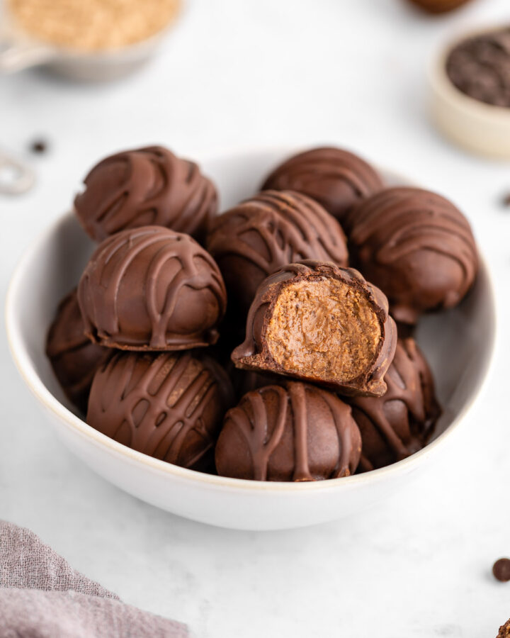 chocolate protein truffles in a white bowl