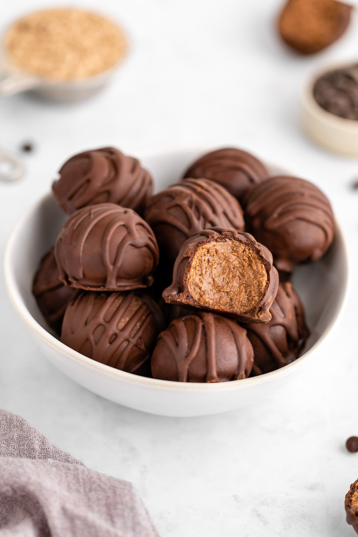 chocolate protein truffles in a white bowl