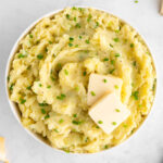 a bowl of vegan garlic and chive mashed potatoes