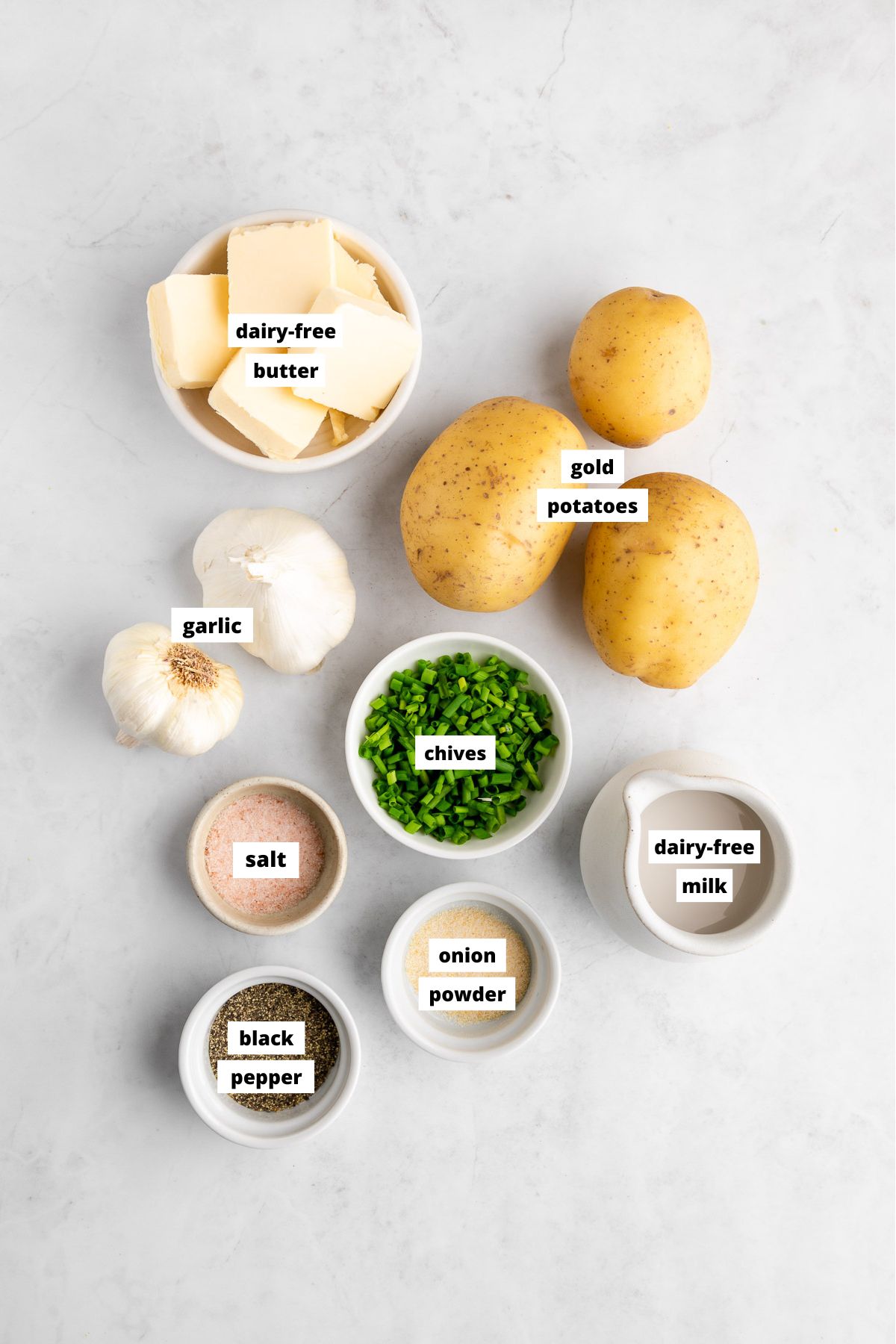 bowls of ingredients for making vegan garlic mashed potatoes