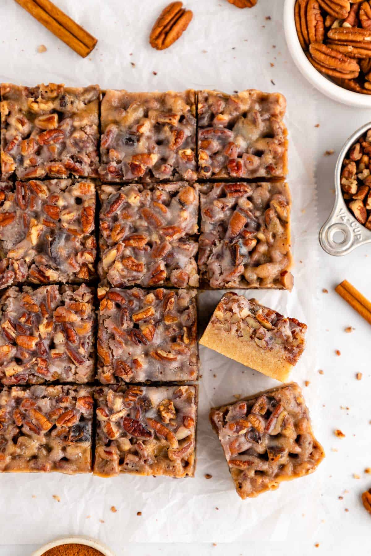 a pile of sliced vegan pecan pie bars with sweetened condensed coconut milk topping