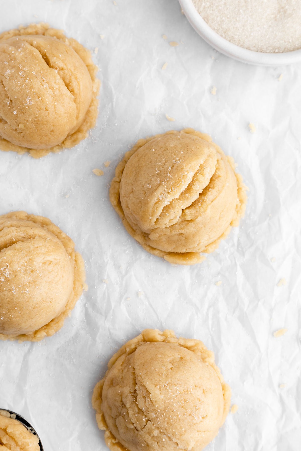 scoops of vegan edible sugar cookie dough on white parchment paper