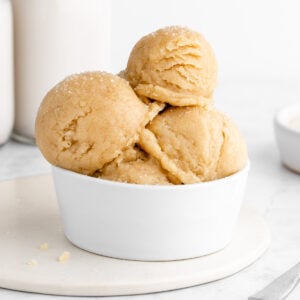 scoops of vegan edible sugar cookie dough stacked in a white bowl