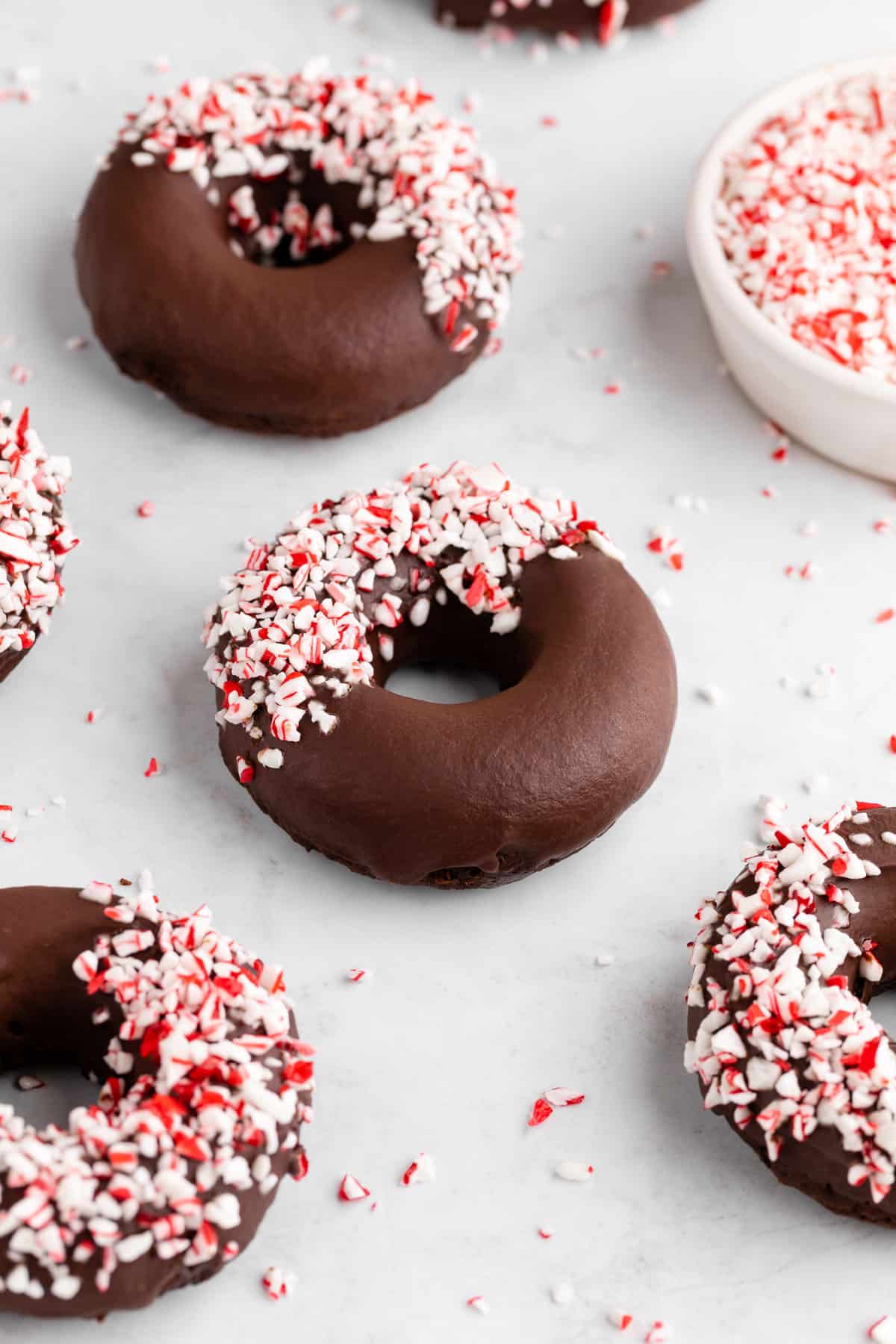 vegan chocolate peppermint mocha donuts with candy canes on top