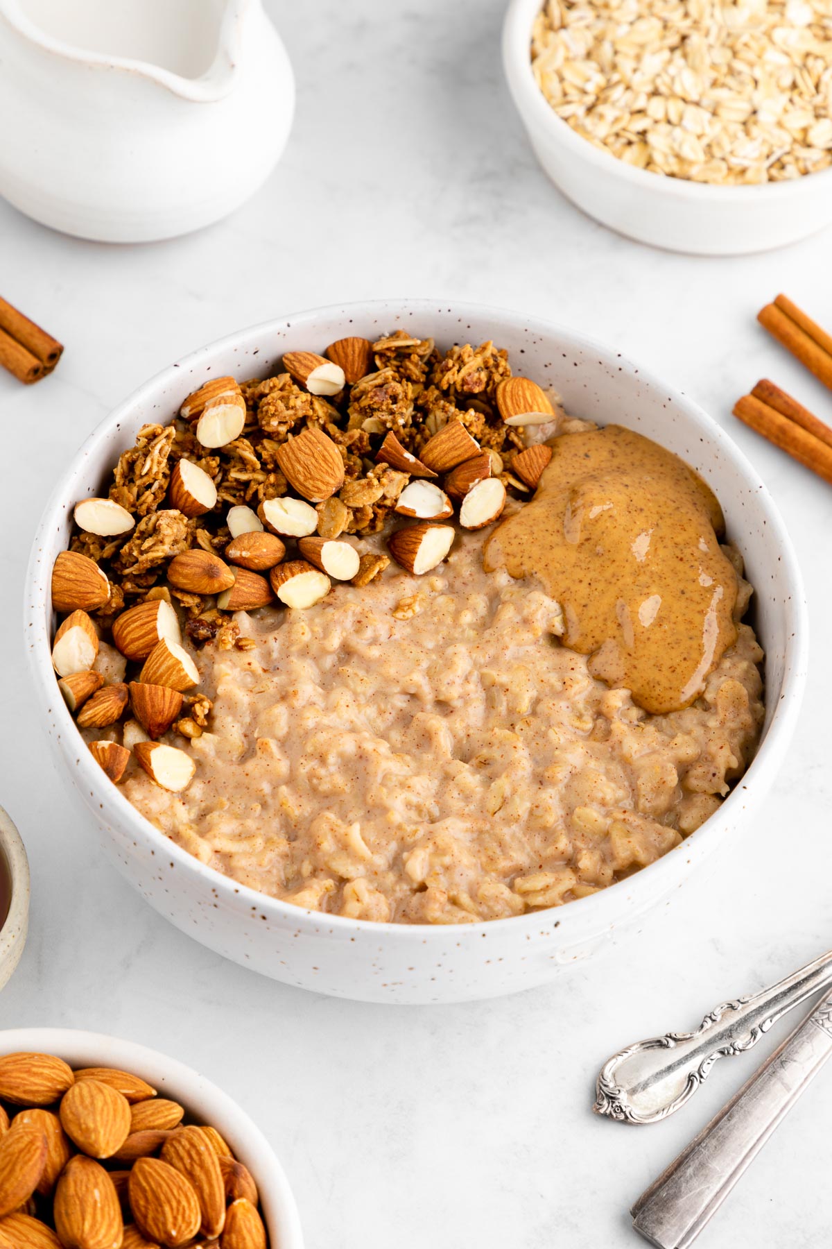 a ceramic bowl filled with almond butter oatmeal